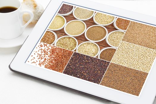 Reviewing pictures of healthy gluten free grains (quinoa, kaniwa, brown rice, millet, amaranth, teff, buckwheat, sorghum) on a digital tablet with a cup of coffee. All screen pictures copyright by the photographer.