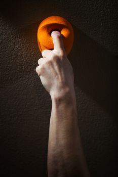 Cropped view of rock climber gripping handhold with one finger