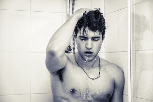 Close up Attractive Young Bare Muscular Young Man Taking Shower with One Hand on his Head with Eyes Closed