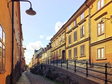 Picturesque cobblestone street with old buildings in Sodermalm, Stockholm.