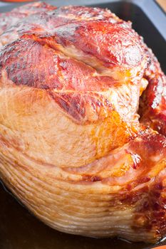 A fresh baked ham rests in the pan prior to being served.