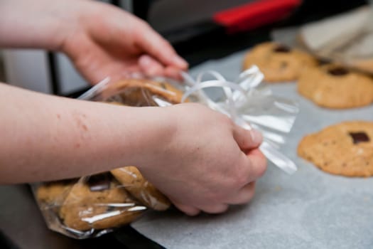 Hand wrapping bisquits in a bakery