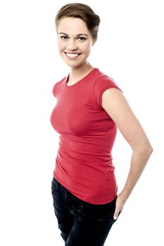 Smiling woman posing hands in back pockets