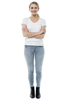 Confident young woman standing with folded arms