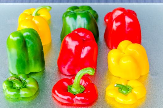 Red, Green, Yellow Bell Pepper washed on silver plate.