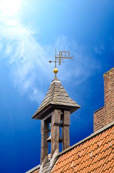 Steeple against a dark blue sky.