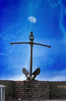 Anchor on a wall. Against a dramatic cloudscape with lightning and moon.