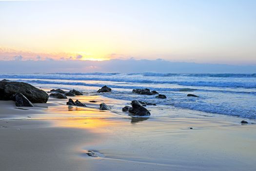 Natural rocks at Praia Vale Figueiras in Portugal at twilight