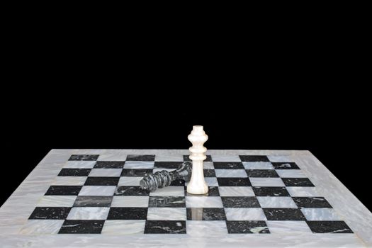 King beats the king, chessplay on a marble chess board