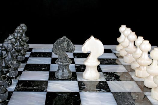 White Knight vs. Black Knight on a marble chess board