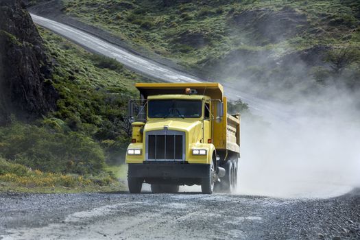 Transport - A heavy truck driving on a rough gravel road in Patagonia in southern Chile.