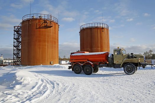 Tank storage crude Oil and fuel truck in winter landscape