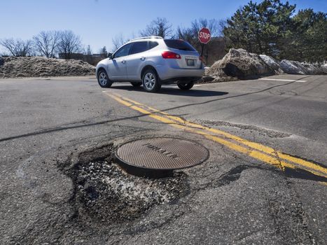 Big pothole caused by freezing and thawing during spring season
