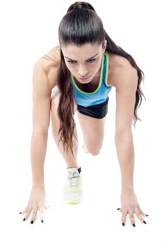 Woman athlete crouched down in starting position
