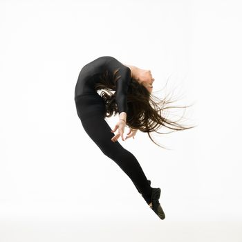 modern style dancer jumping, posing on white background