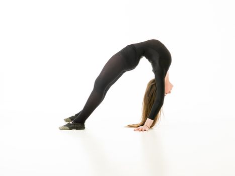 young girl doing gymnastics bridge isolated on white background