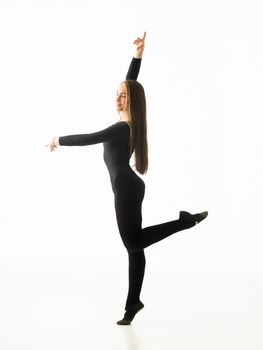 graceful ballerina dancing in studio, posing on white background