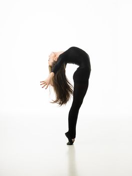 young beautiful dancer posing on white studio background