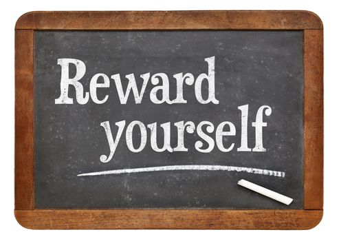 Reward yourself - motivational words on a vintage slate blackboard