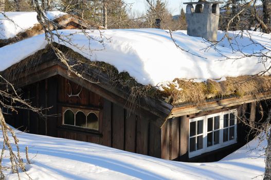 Cottage with melting snow on the roof