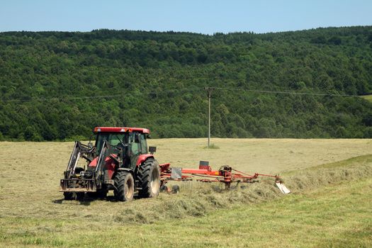 Tractors on field collected hay and make the packages