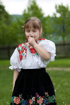 Little girl in costume with sniffs the flower