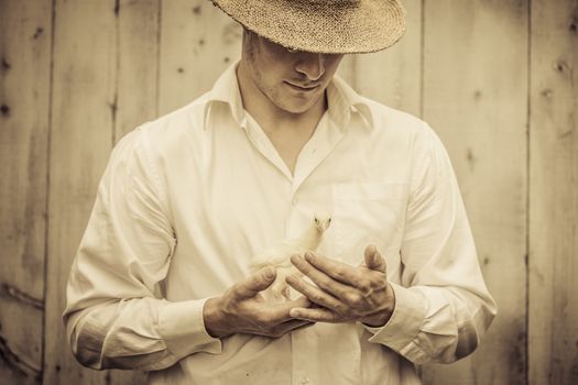 Farmer Holding a Baby Turkey in its hand