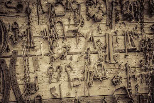 Wall Filled with Old Rusty Tools Hanging on the wall