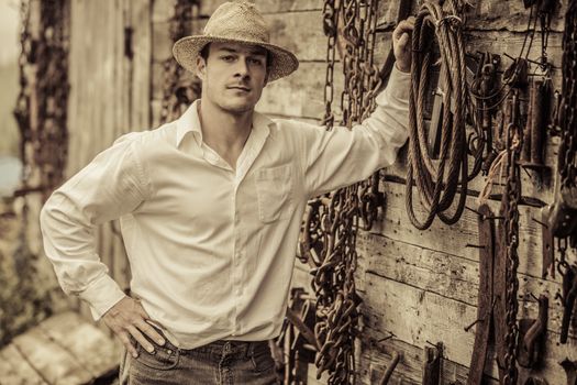 Farmer Portrait in front of a Wall Full with Old Rusty Tools