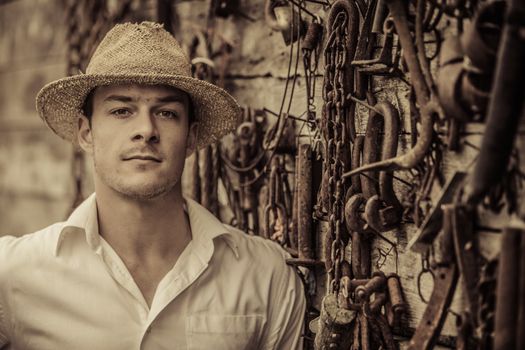 Farmer Portrait in front of a Wall Full with Old Rusty Tools