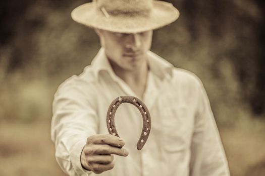 Lucky Farmer Holding a Horseshoe in his right hand