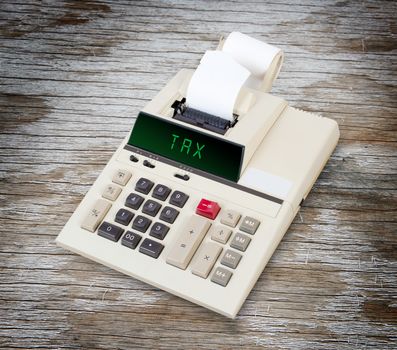 Old calculator showing a text on display - tax