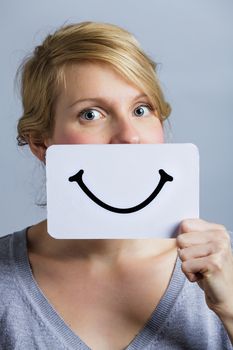 Happy Portrait of a Woman Holding a Smiling Mood Board