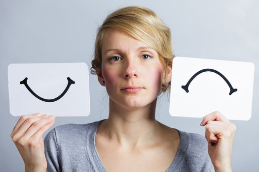 Portrait of a Woman Holding Happy and Unhappy Survey Mood Board