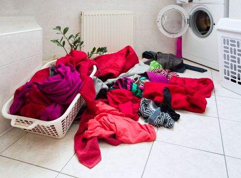 pile of dirty clothes ready for the wash in home bathroom
