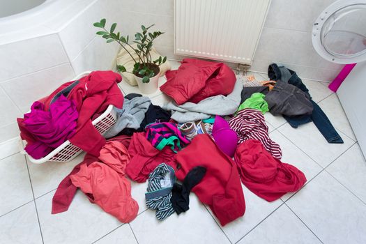 pile of dirty clothes ready for the wash in home bathroom