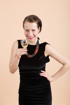 Studio portrait of a beautiful young brunette woman holding a glass of white wine
