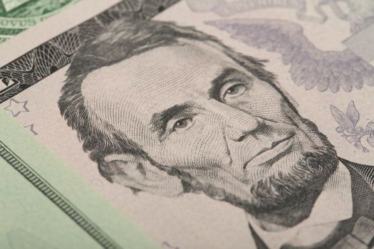 Macro of Abraham Lincoln on five USA one dollar banknote