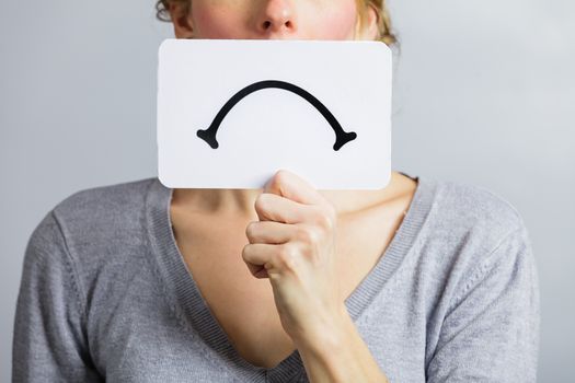 Unhappy Portrait of a Woman Holding a Sad Mood Board