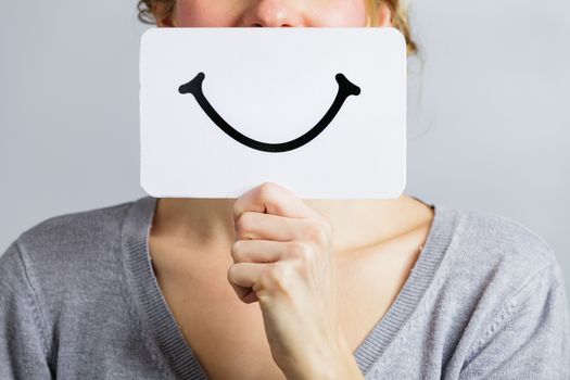 Happy Closeup of a Woman Holding a Smiling Mood Board