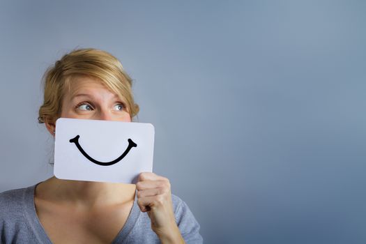 Happy Portrait of a Woman Holding a Smiling Mood Board