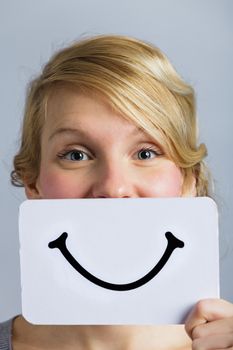 Happy Portrait of a Woman Holding a Smiling Mood Board
