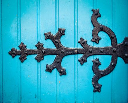 Vintage Ornate HInge On A Bright Blue Painted Church Door