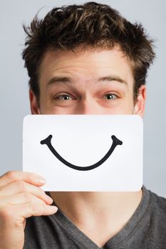 Happy Portrait of a Man Holding a Smiling Mood Board