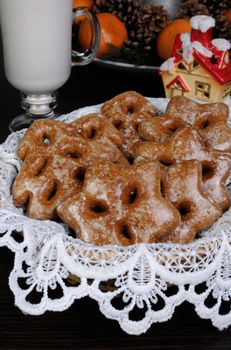 Gingerbread in the form of  trees and stars on the Christmas table with milk