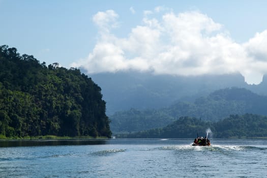 Lake mountain with boat and blue sky