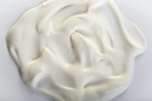 Close up view of cream on white background