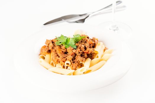 Pasta. Penne Pasta with Bolognese Sauce, Parmesan Cheese and Basil, Fork. Italian Cuisine. Mediterranean food