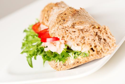 Prawn sandwich on white plate. Studio shot