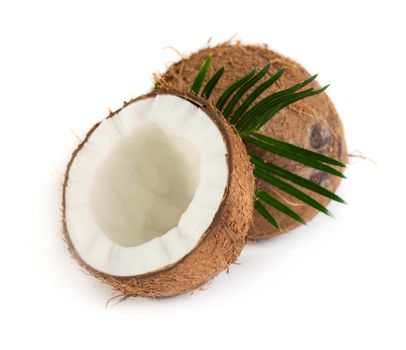 Coconut with green leaves isolated on white background